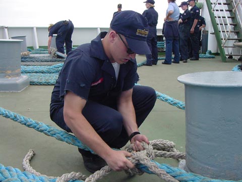 deck seamanship assessments: 4/c Dan Dirusso (Medford,MA) ties a stopper on a mooring line for the qual. Other freshmen await their turn to shine in the background.