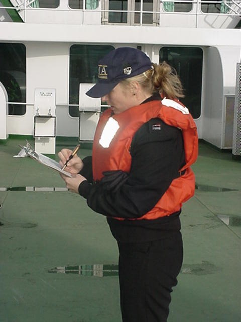 Lt Twiss: Lt Heather Twiss (MMA '97 and second company officer when ashore) counts noses for lifeboat #6. All 596 members of the cadets, officers, and crew of the ship must be accounted for in less then 15 minutes.