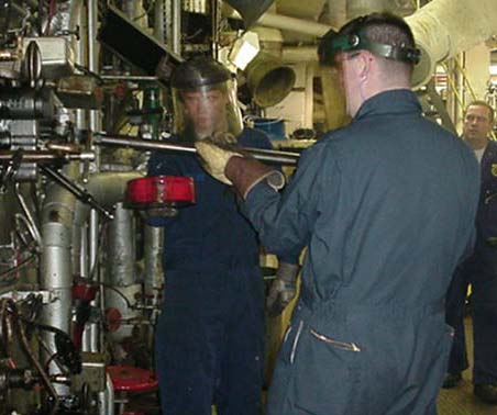 engine watch: 2/c Tom Preston (Hingham,MA)and 3/c Pat Calder (Harpswell,ME)  changing burners while on watch in the pit 