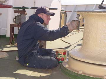 beige paint: 4/c Sean Steinberg (Cape Coral,FL)dons warm clothing to paint the capstan.