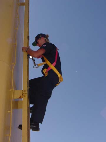 Lt Twiss aloft: Lt. Heather Twiss (MMA '97 and 2nd Company Officer) demonstrates the proper way to go aloft on a ship.