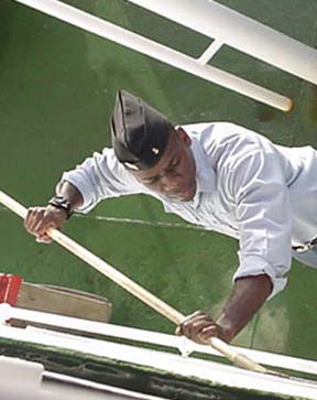 non descrimination: Even first class cadets have to work aboard ship, as 1/c Fred Cleare (Bahamas) knows full well.