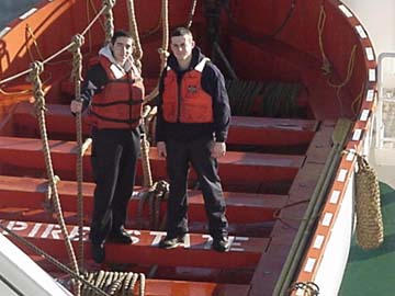 4/c Ferraioli: Freshmen Andrew Ferraioli (Sandwich,MA) and Gerard DeModena (East Boston,MA)in an open lifeboat.