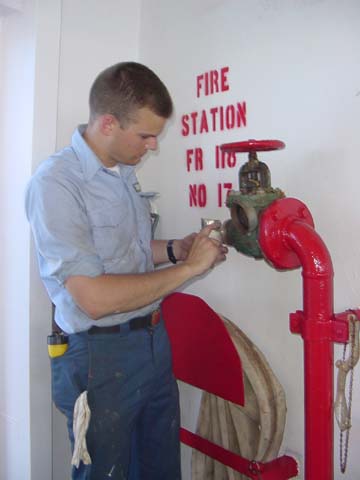 fire station: a cadet inspects a fire station aboard ship before a drill.