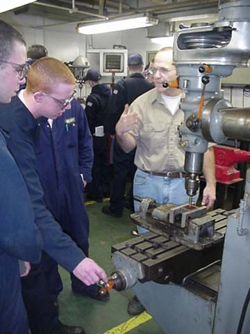 machine shop: Mr. Chip Hayden, an MMA staff officer, teaches 4/c cadets the art of creating things from metal.