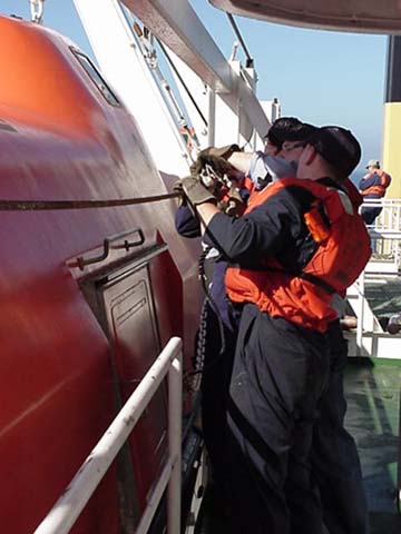 lifeboat train: cadets get ready to lower one of the orange beheamoths