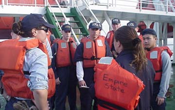 in charge: Captain Linda Letourneau (MMA '87) instructs cadets in the finer points of launching lifeboats.