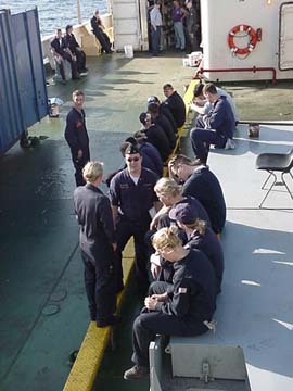 6 hatch: tired cadets share sea stories after the ship pulls out of port.