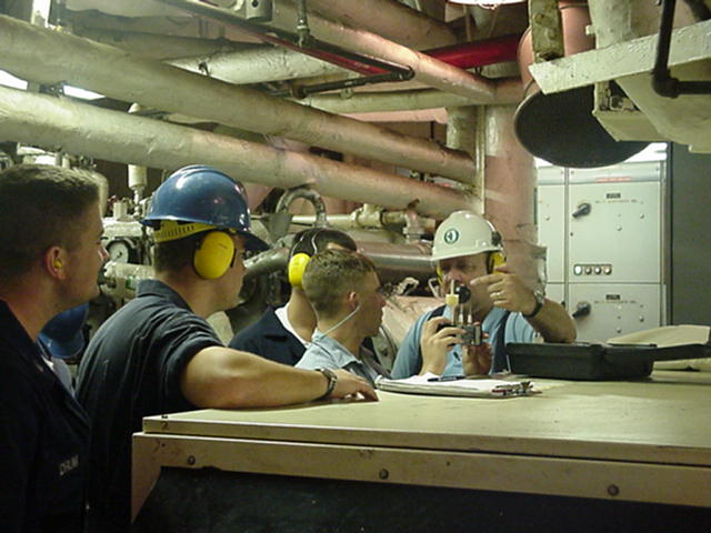 Instruction in the enginroom: Professor Jim Hathaway demonstrates the use of the "heat stress analyzer" to MSEP cadets in the hot confines of the "Pit".