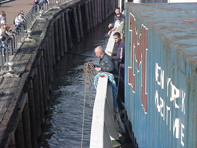 NOLA docking: 1/c Devon Brady and 1/c Kaizer Bharucha toss the first line ashore in New Orleans.