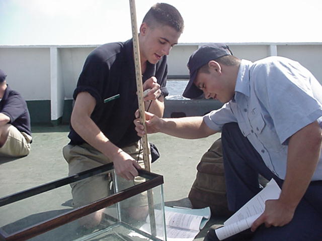 wavemeasure.jpg: Cadets measure the wave tank for the wave speed experiments. Mike Capano and Mike Brides, both freshmen, take the measurements.